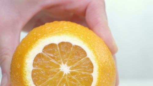 Cutting Orange on Chopping Board on White Background