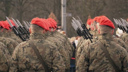 A Lot of Soldiers in Red Berets and Green Uniform Stand with Their Backs To the Camera
