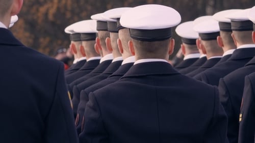 Group of People in Uniform Marching in Formation