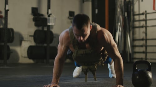 Deportista haciendo flexiones en el gimnasio