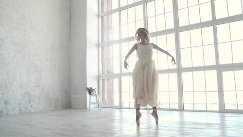 Elegant Ballerina Dancing in a Bright White Studio