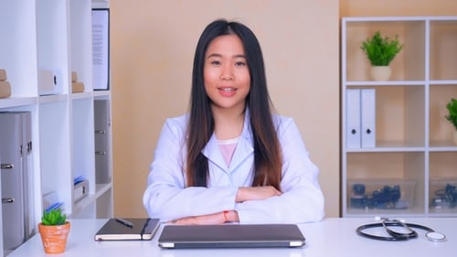 Female Doctor Speaking to Camera in Office