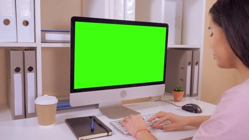 Woman Types at Computer with Green Screen