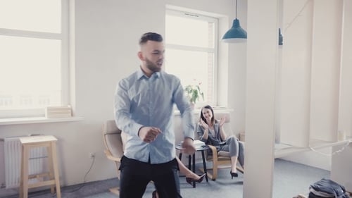Office Workers Applaud Dancing Colleague Celebration