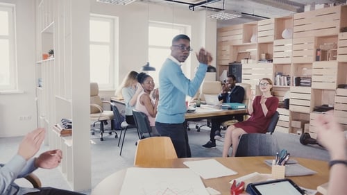 Joyful Celebration: Office Colleagues Applaud Dancing Man