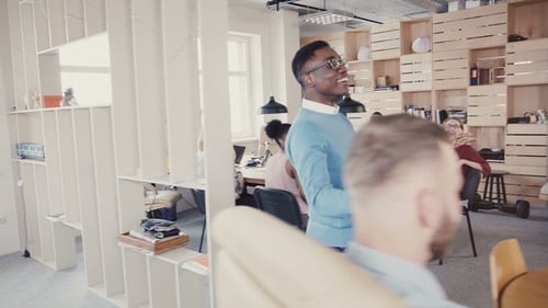Happy African American Man Gives High Fives To Office Colleagues. Celebrating Business Success with