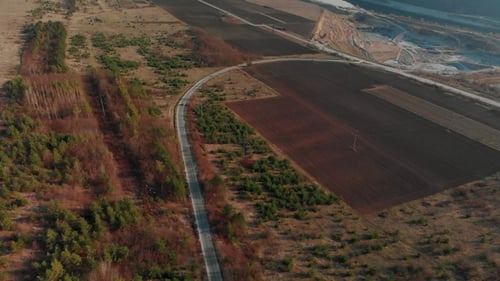 Aerial View of Car Driving Winding Switchback Road. Cinematic Toned. Drone Shot Flying Over