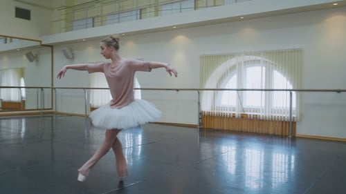 Ballerina in White Ballet Tutu Dress Practicing in Dance Studio or Gym. Woman Jumping in Class Room