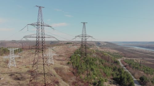 Electric High Voltage Pylon Against Sky. Aerial View From Drone To Power Lines. Nature Landscape