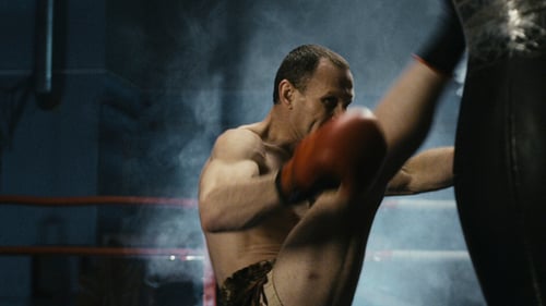 Shirtless Boxer Punching Bag in Gym