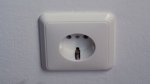Hand Plugs and Unplugs White Electrical Plug