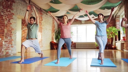 Group of People Making Yoga Exercises in Gym 37