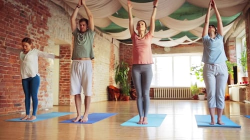 Group of People Making Yoga Exercises in Gym 40