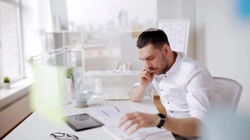 Businessman with Papers and Smartphone at Office 11