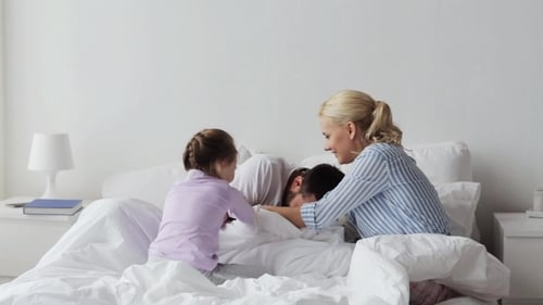 Family Fun Together in Bed at Home