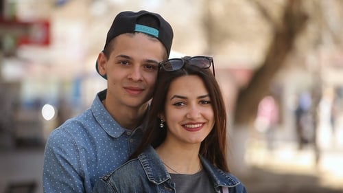 Lovely Young Couple Stand in an Airy Alley and Smile Happily in Spring