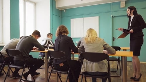 Female Teacher Speaks To Students During a Lesson in University