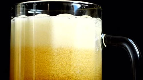 Refreshing Beer Poured into Glass Mug