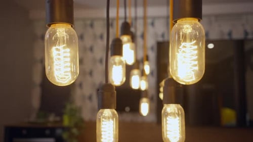 Turned on Lamps Hanging on Ceiling in Luxurious Furniture Store Indoors