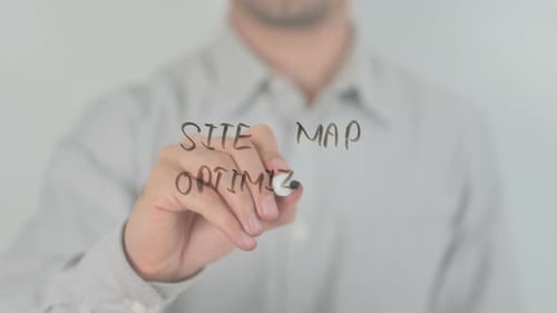 Person Writing Site Map Optimization on Clear Surface