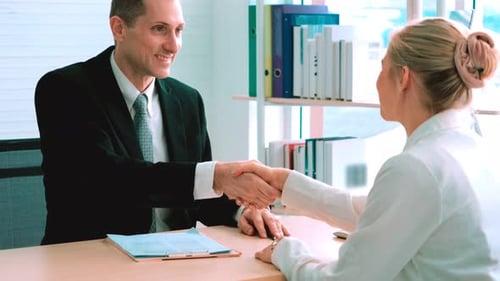 Business People Handshake in Office to Close Deal
