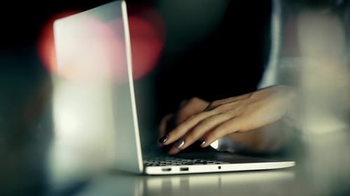 Woman Working on Laptop at Night at Home