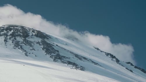 Picturesque View of Clouds Floating Over Hight Mountain Peak