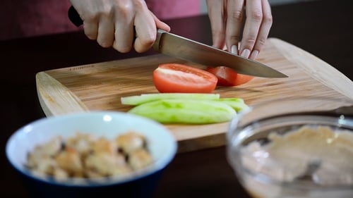 Tomato Slicing with Knife on Cutting Board