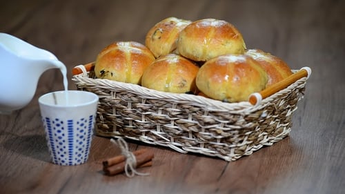 Easter Hot Cross Buns in a Basket. Pour Milk Into a Cup