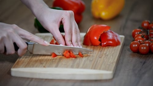 Chopping Red Bell Pepper on a Wooden Board