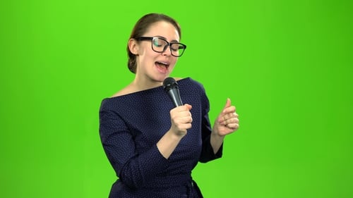 Woman Singing Energetically into Microphone on Green Screen