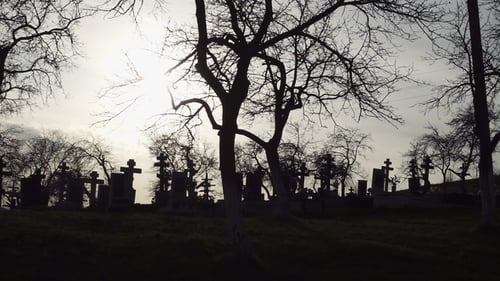 Halloween Background. Old Graveyard with Ancient Crosses at Sunset