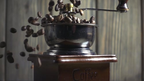 Roasted Coffee Beans Falling Into Vintage Grinder