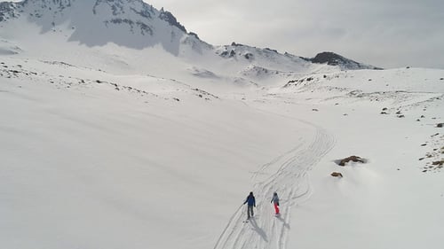 Aerial View of Skiers in Snowy Mountains