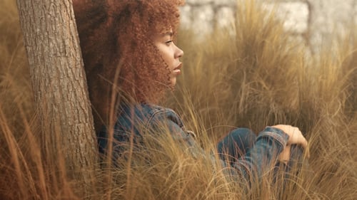 Black Mixed Race Woman with Big Afro Curly Hair in Lawn Field with High Dry Autumn Hay Grass and