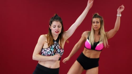 Two Energetic Women Dancing in Studio Setting