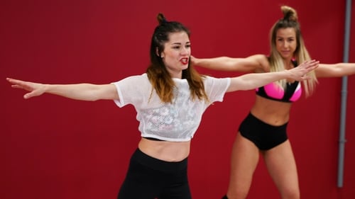 Beautiful Sexy Girls on a Red Wall Background Perform Fitness Exercises on Shoes with Spring