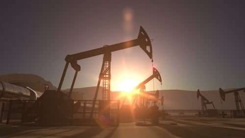 Sunrise Over Oil Field with Pumpjacks and Pipeline