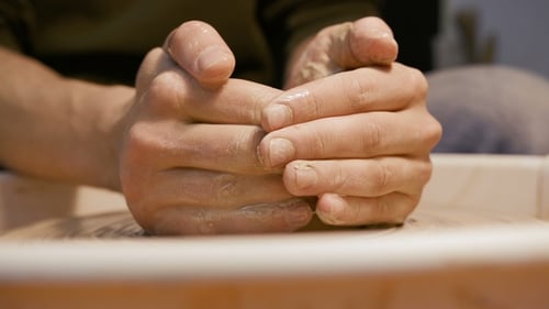 Man Works with a Potter's Wheel