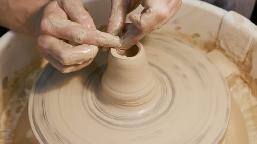 Man Works with a Potter's Wheel