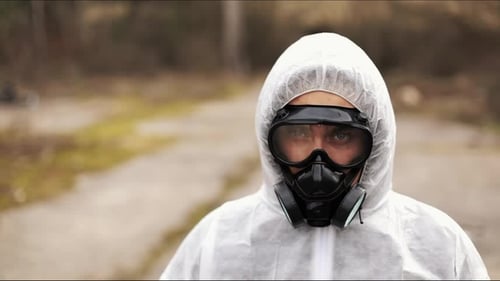 Person in Hazmat Suit and Gas Mask