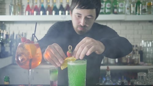 Bartender Prepares Colorful Cocktails at the Bar