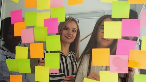 Team Brainstorming with Colorful Sticky Notes in Office