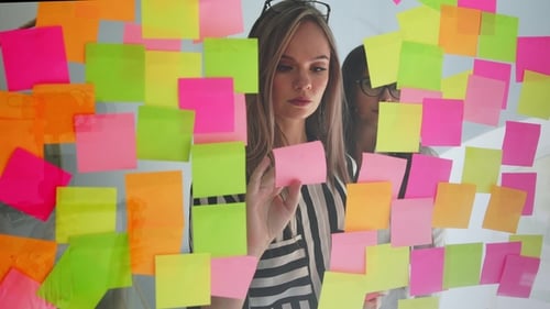 Brainstorming Session With Sticky Notes in Modern Office