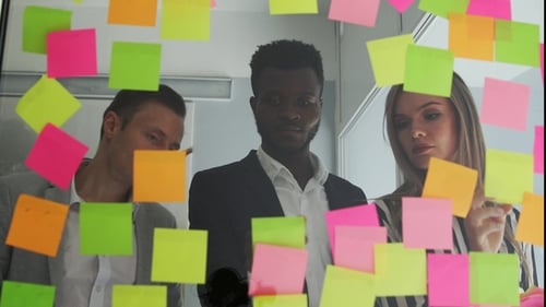 Creative Team Collaborating With Sticky Notes in Office