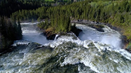 Aerial View of Waterfall Flowing Through Forest