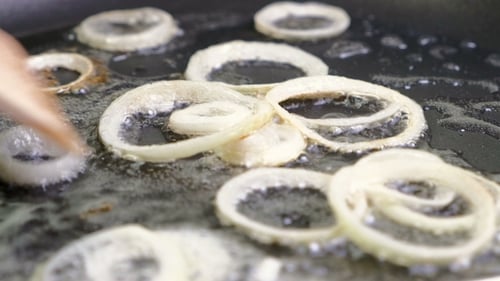 Frying Sliced White Onions in Pan with Oil