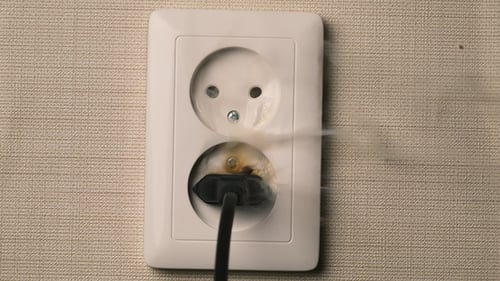 Fire in European Style Wall Socket. Concept: House Insurance, the Insured Event, the Cause of Fire