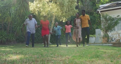 Happy Family Walking Together on Sunny Lawn