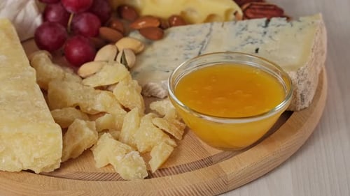 Cheese Board With Grapes, Nuts, and Honey